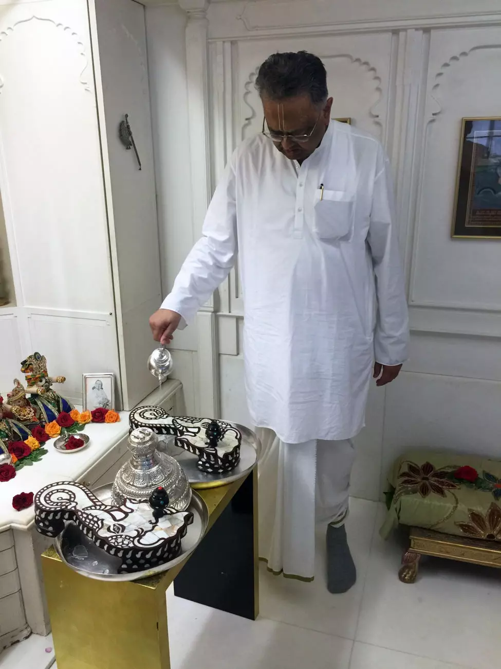 Sri Nathji das doing abhisek of Sri Nityananda's padukas