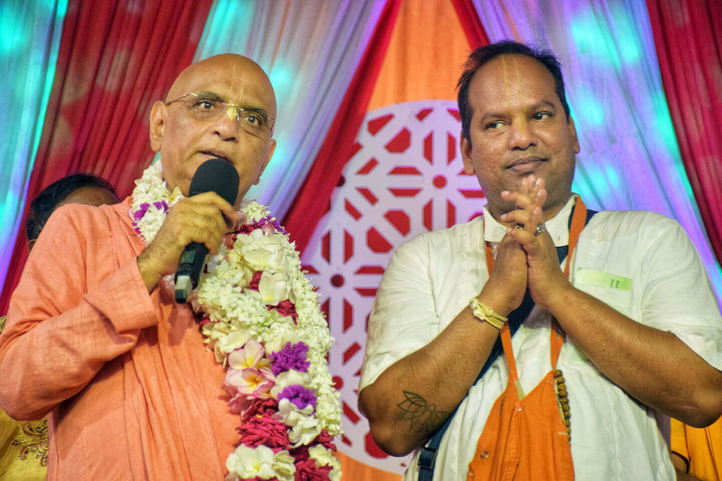 Bhakti Caru Swami with Braja Vilas das on stage at program in Bangladesh